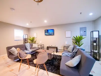 a living room with two couches and a table at Spacious 2BR Apartment in Jersey City - Easy NYC Access in Jersey City