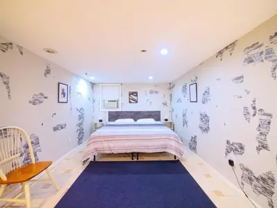 a bedroom with a bed and a blue rug at Spacious 2BR Apartment in Jersey City - Easy NYC Access in Jersey City