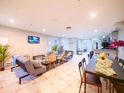 a large living room with a table and chairs at Spacious 2BR Apartment in Jersey City - Easy NYC Access in Jersey City