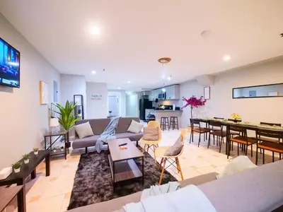 a living room with a couch and a table at Spacious 2BR Apartment in Jersey City - Easy NYC Access in Jersey City