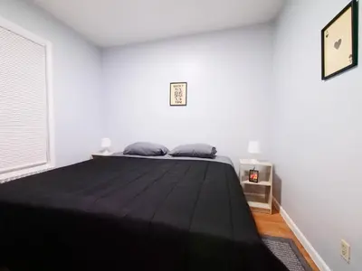 a bedroom with a large bed in a white room at NYC Views & Comfort - Modern 2-Bedroom Apartment in Jersey City