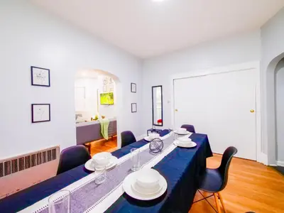 a dining room with a blue table and chairs at NYC Views & Comfort - Modern 2-Bedroom Apartment in Jersey City