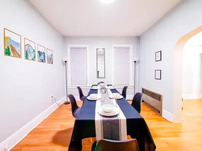 a dining room with a long table and chairs at NYC Views & Comfort - Modern 2-Bedroom Apartment in Jersey City