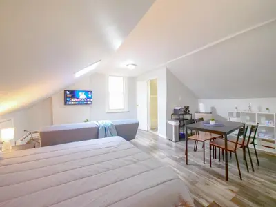 a bedroom with a large bed and a table at Cozy Jersey City Apt near NYC Free Wi-Fi & Great Location in Jersey City