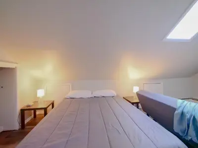 a large bed in a room with two tables at Cozy Jersey City Apt near NYC Free Wi-Fi & Great Location in Jersey City