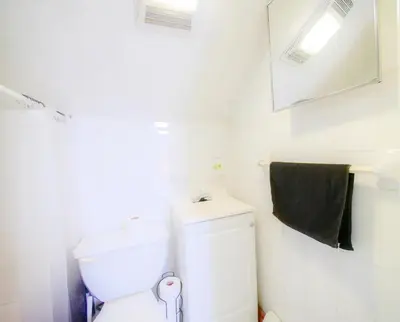 a bathroom with a white toilet and a mirror at Cozy Jersey City Apt near NYC Free Wi-Fi & Great Location in Jersey City