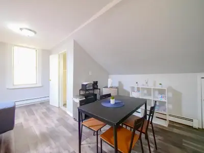 a dining room with a black table and chairs at Cozy Jersey City Apt near NYC Free Wi-Fi & Great Location in Jersey City