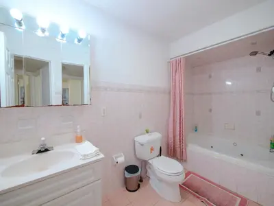 a bathroom with a sink and a toilet and a tub at Spacious Apt near NYC 7BR Family-Friendly & Modern Amenities in Jersey City