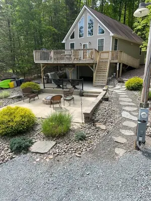 a house with a deck and a patio at Wallenpaupack Lake house in Greentown