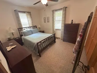 a bedroom with a bed and a dresser at Wallenpaupack Lake house in Greentown