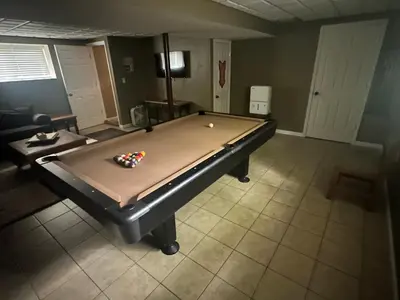 a pool table in the middle of a room at Wallenpaupack Lake house in Greentown