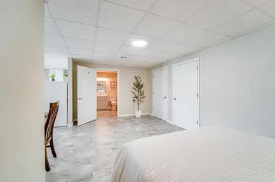 a white bedroom with a bed and a dining room at Mtn-View Studio 18 Mi to Penn State! in Spring Mills