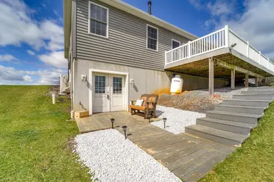 a house with a porch with a deck and a stairway at Mtn-View Studio 18 Mi to Penn State! in Spring Mills