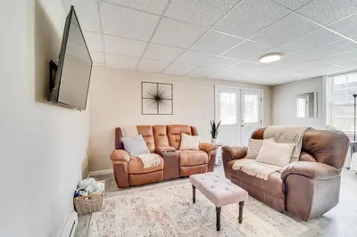 a living room with two leather couches and a tv at Mtn-View Studio 18 Mi to Penn State! in Spring Mills