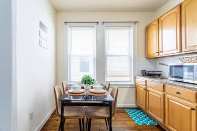 a dining room with a table and chairs in a kitchen at Family Apt: 2BR FREE Parking Airprt City Links in Newark