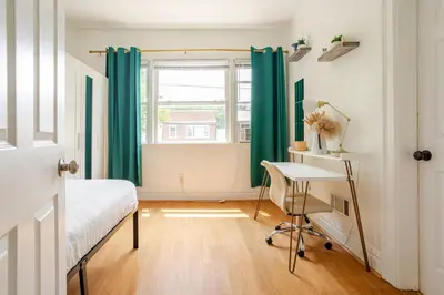 a bedroom with a bed and a desk and a window at 6-Guest Jersey City Haven: Location-Comfort-Vibes in Jersey City