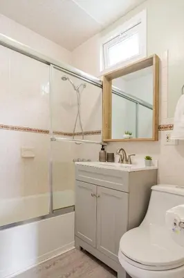 a bathroom with a shower and a toilet and a sink at 6-Guest Jersey City Haven: Location-Comfort-Vibes in Jersey City