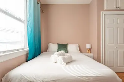 a bedroom with a bed with towels on it at City Outside Serenity Inside: 2B1B NYC - 40 Min in Jersey City