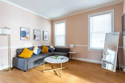 a living room with a couch and a table at City Outside Serenity Inside: 2B1B NYC - 40 Min in Jersey City