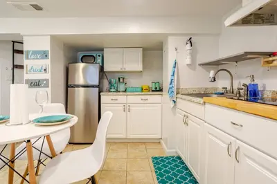 a kitchen with white cabinets and a table at Big City Life: 1BR Apt wNetflix Easy NYC Access in Jersey City