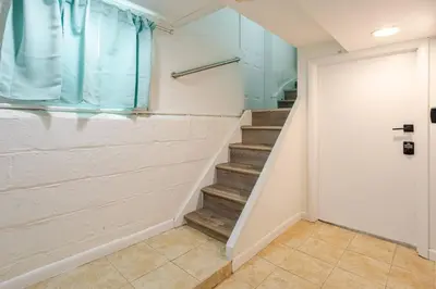 a staircase in a house with a door at Big City Life: 1BR Apt wNetflix Easy NYC Access in Jersey City