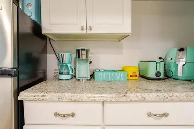 a kitchen counter with a coffee maker and appliances on it at Big City Life: 1BR Apt wNetflix Easy NYC Access in Jersey City