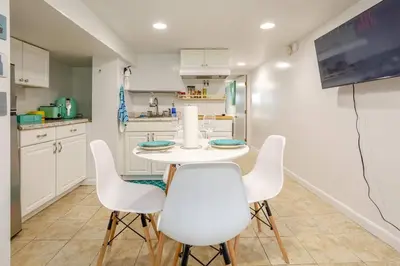 a kitchen with a white table and white chairs at Big City Life: 1BR Apt wNetflix Easy NYC Access in Jersey City