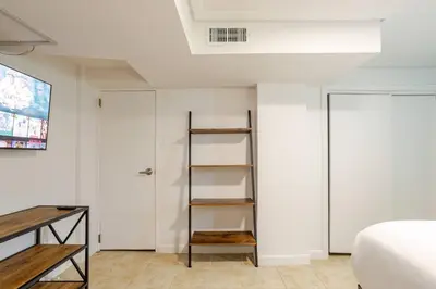 a room with a bed and a book shelf at Big City Life: 1BR Apt wNetflix Easy NYC Access in Jersey City