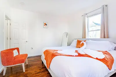 a bedroom with a bed with a swan on it at Family Urban: 2BR FREE Pkng Airport NYC Ease in Newark