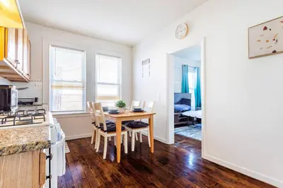 a kitchen and dining room with a table and chairs at Family Urban: 2BR FREE Pkng Airport NYC Ease in Newark
