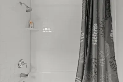 a shower curtain in a bathroom next to a tub at Apartmint at The Metropolitan - Philadelphia in Philadelphia