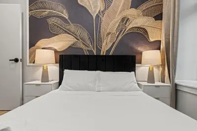 a bedroom with a white bed and two lamps at Apartmint at The Metropolitan - Philadelphia in Philadelphia