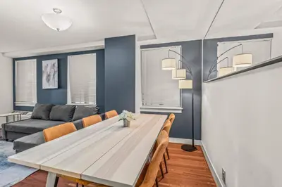 a dining room with a table and chairs and a couch at Apartmint at The Metropolitan - Philadelphia in Philadelphia