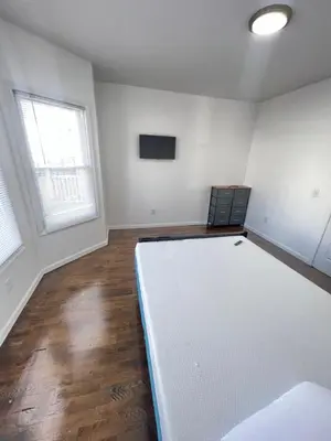 an empty room with a large white mattress at Newly renovated furnished home in Newark
