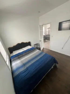 a bedroom with a bed with a blue comforter at Newly renovated furnished home in Newark