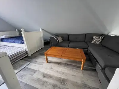 a living room with a couch and a coffee table at Fully updated home with hot tub in amenity filled community in Lackawaxen