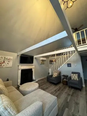 a living room with two couches and a fireplace at Fully updated home with hot tub in amenity filled community in Lackawaxen