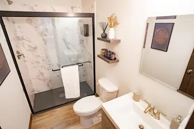 a bathroom with a shower and a toilet and a sink at Luxury Chalet with hot tub in scenic Poconos in Albrightsville