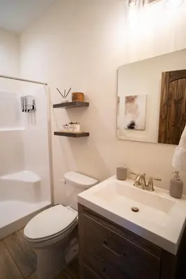 a bathroom with a white toilet and a sink at Luxury Chalet with hot tub in scenic Poconos in Albrightsville