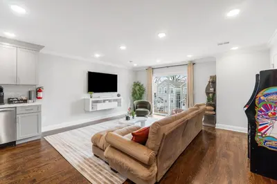a living room with a couch and a tv at Orange's Oasis in East Orange