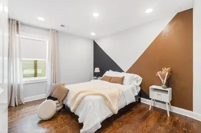 a bedroom with a large bed and a window at Orange's Oasis in East Orange