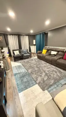 a living room with a couch and a large rug at Rooms available in a single Family home shared with Host in Willingboro