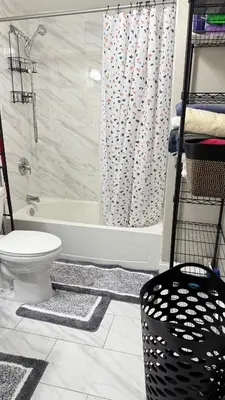 a bathroom with a tub and a toilet and a shower at Rooms available in a single Family home shared with Host in Willingboro