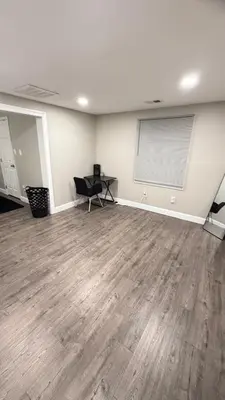 an empty room with a wooden floor and a desk at Rooms available in a single Family home shared with Host in Willingboro