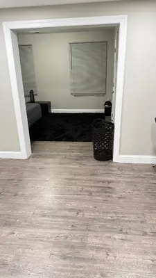 an empty living room with a couch and a floor at Rooms available in a single Family home shared with Host in Willingboro