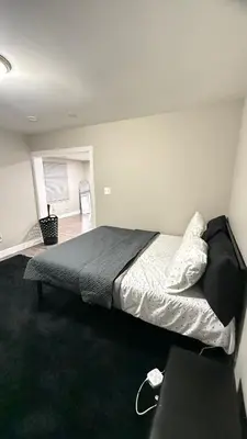 a large bed in a white room with at Rooms available in a single Family home shared with Host in Willingboro