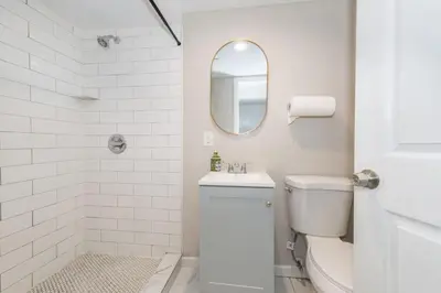 a white bathroom with a toilet and a sink at Cozy Basement 2 Bed in Passaic in Passaic
