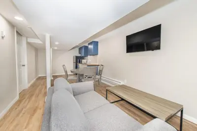 a living room with a couch and a table at Cozy Basement 2 Bed in Passaic in Passaic