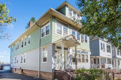 a large house with white and green trim at Cozy Basement 2 Bed in Passaic in Passaic
