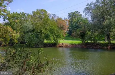 a view of a river with trees in the background at RiverFront Villa- Sleeps 11 in Lancaster